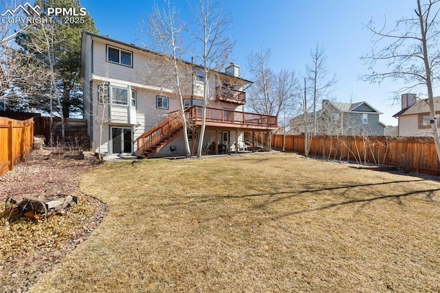 back of property with a fenced backyard, stairs, a wooden deck, and a yard