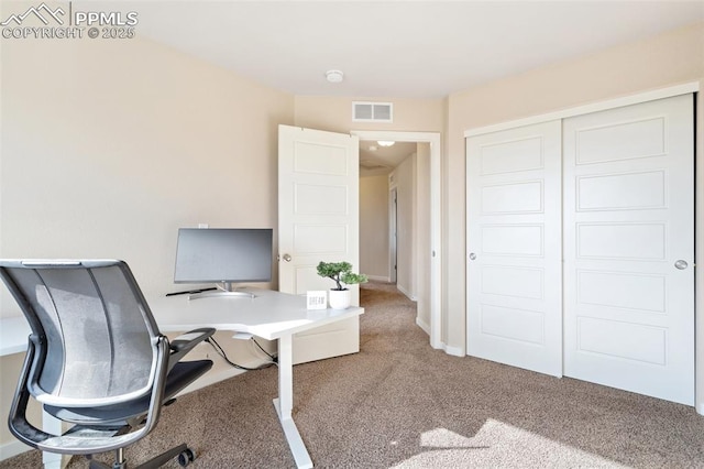 carpeted office space featuring visible vents and baseboards