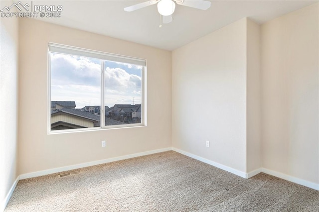 carpeted spare room featuring visible vents, ceiling fan, and baseboards