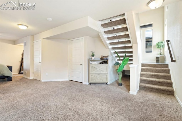 additional living space with stairway, carpet flooring, visible vents, and baseboards