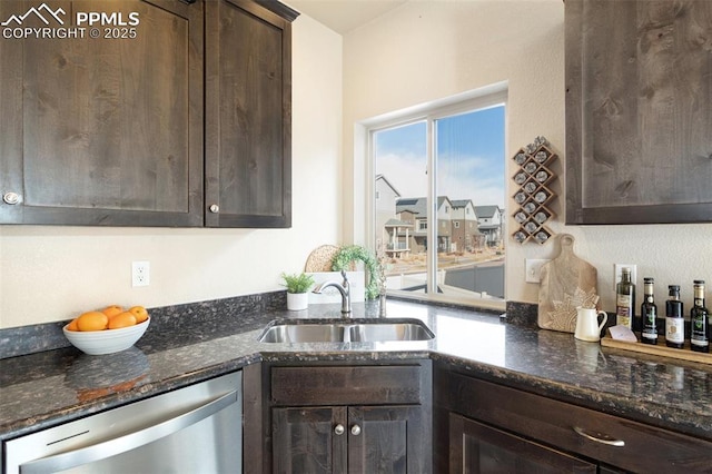 kitchen featuring dishwasher, dark stone countertops, dark brown cabinets, and a sink