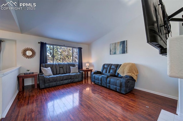 living room featuring vaulted ceiling and dark hardwood / wood-style floors