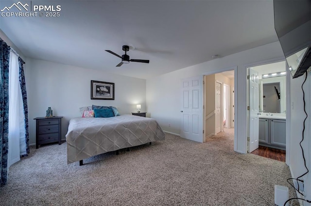 carpeted bedroom featuring ceiling fan and ensuite bath