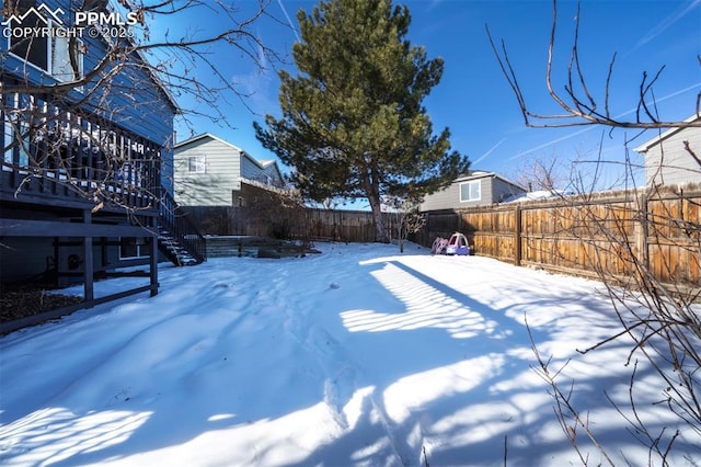 view of yard layered in snow