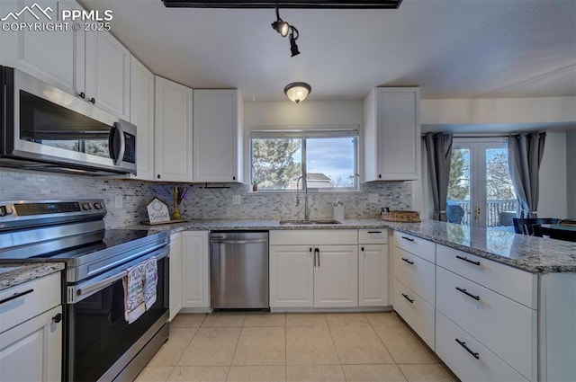 kitchen with stainless steel appliances and white cabinets