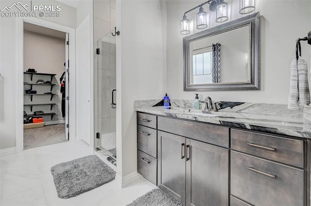 bathroom with vanity and a shower with door