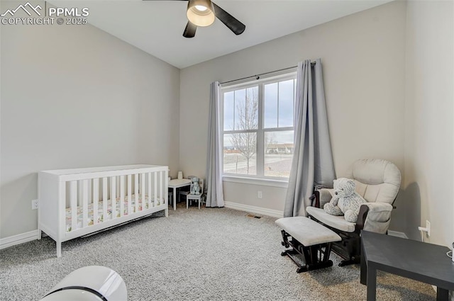 carpeted bedroom with a nursery area and ceiling fan