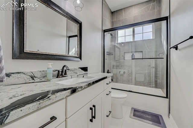 full bathroom with vanity, combined bath / shower with glass door, tile patterned floors, and toilet