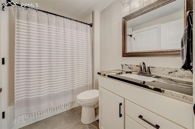 bathroom featuring vanity, toilet, and tile patterned flooring