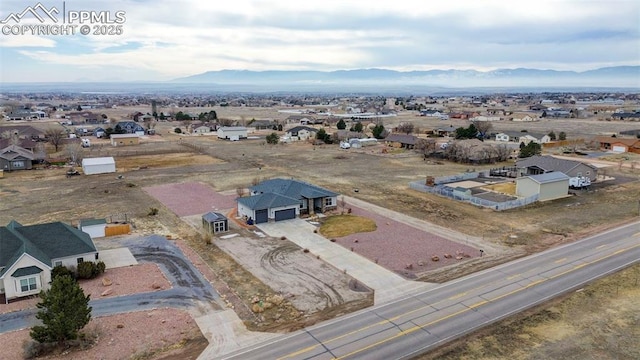 birds eye view of property with a mountain view