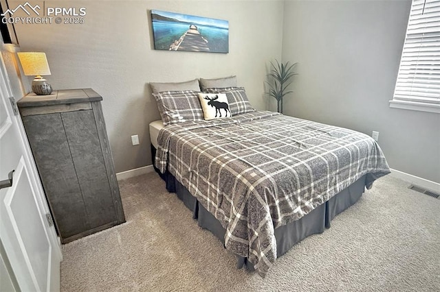 bedroom with baseboards, visible vents, and carpet flooring