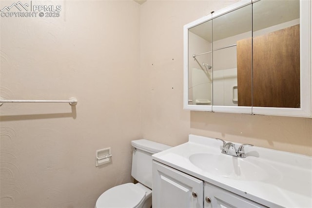 bathroom with vanity, toilet, and walk in shower