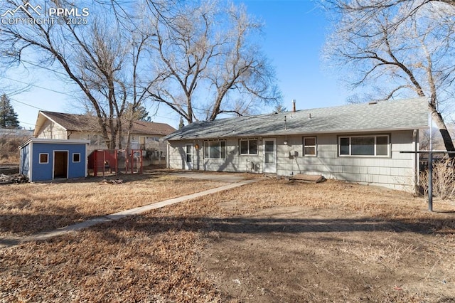 ranch-style home with a storage shed