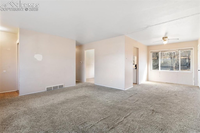 spare room with ceiling fan and light carpet