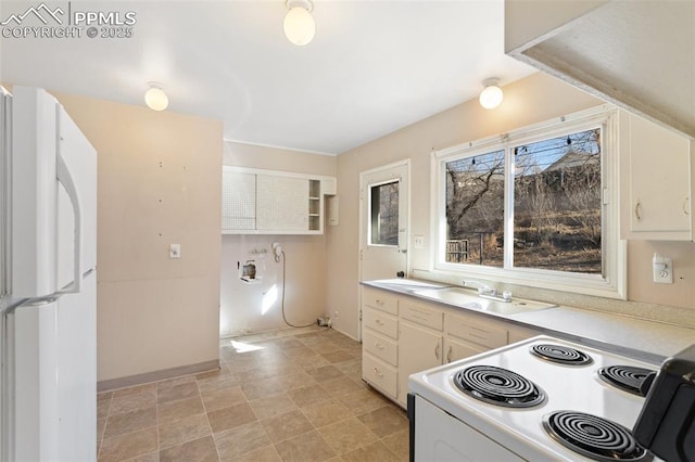 kitchen with white cabinetry, sink, and white appliances