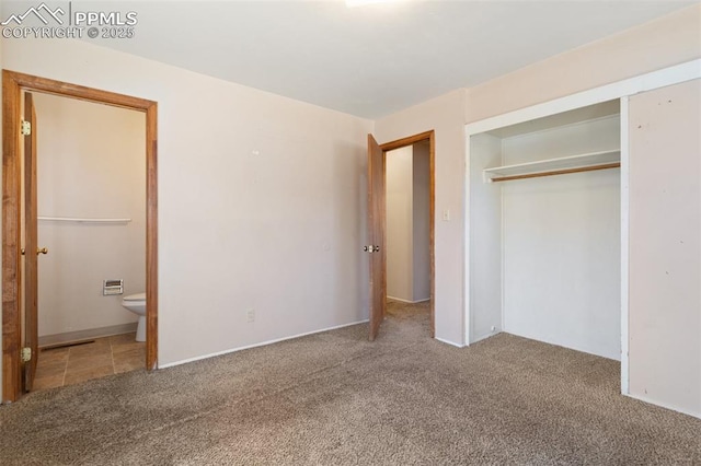 unfurnished bedroom with connected bathroom, carpet floors, and a closet