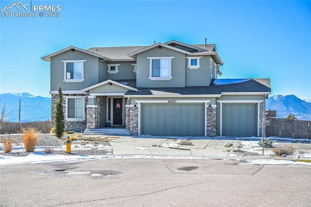 view of front of house featuring a garage and a mountain view