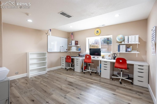 office area with light hardwood / wood-style floors