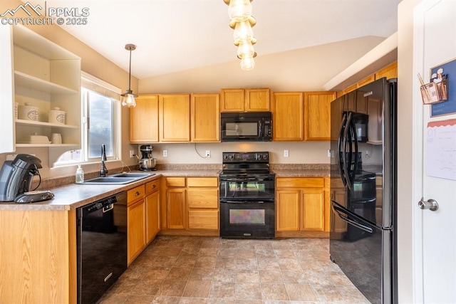 kitchen featuring pendant lighting, vaulted ceiling, sink, and black appliances