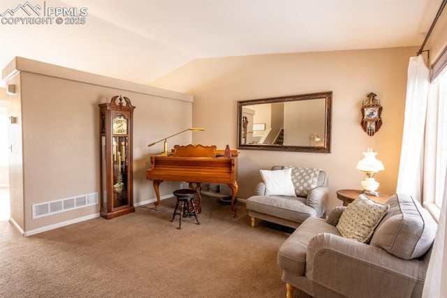 living area with carpet floors and vaulted ceiling