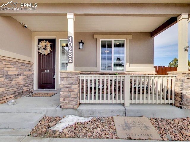 doorway to property featuring a porch