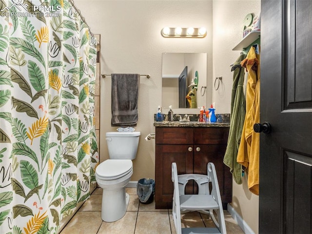 bathroom featuring tile patterned flooring, vanity, and toilet