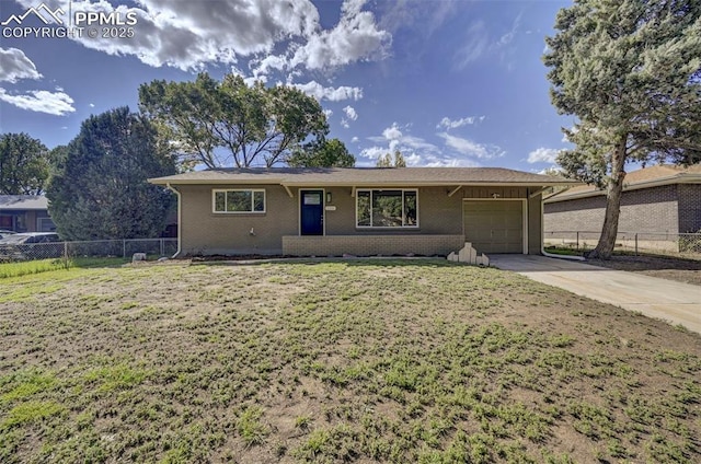 ranch-style home with a garage and a front yard