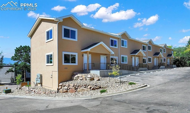 multi unit property featuring a residential view and stucco siding