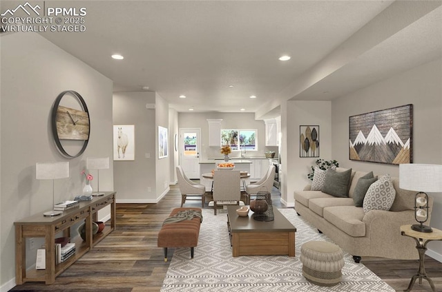 living room featuring recessed lighting, decorative columns, baseboards, and wood finished floors