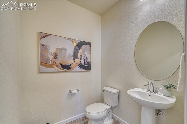 bathroom featuring sink, hardwood / wood-style flooring, and toilet