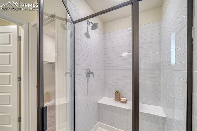 bathroom with a shower with door