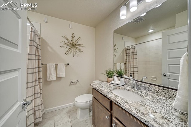 bathroom featuring vanity, tile patterned floors, and toilet