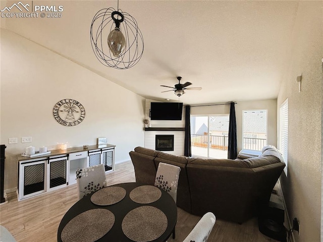 living room featuring ceiling fan and light wood-type flooring