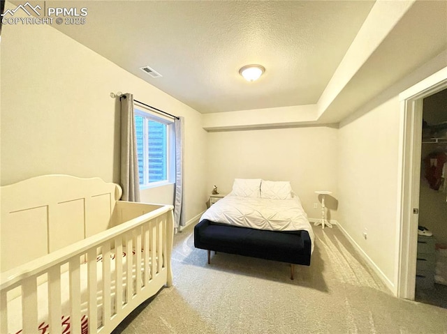 carpeted bedroom with a textured ceiling