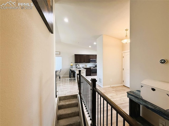 stairs with sink and wood-type flooring