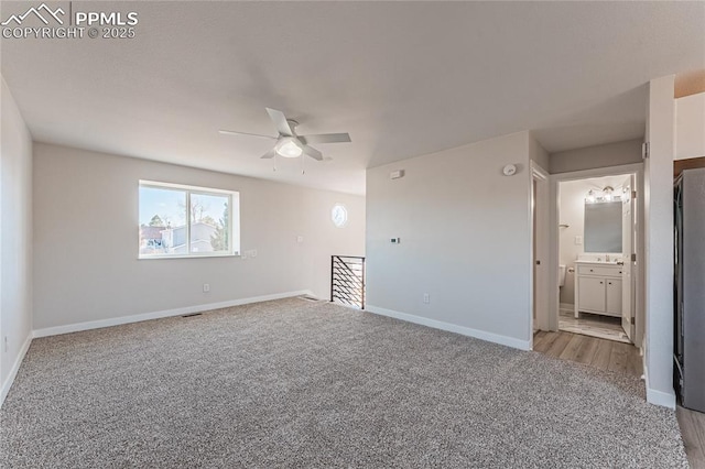 carpeted empty room with ceiling fan