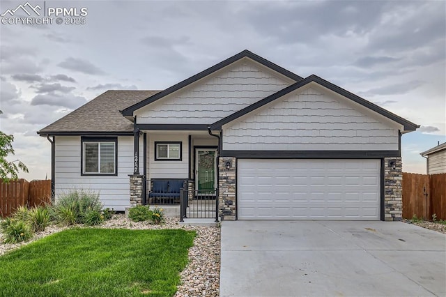 view of front of house with a garage, a front lawn, and covered porch