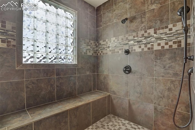 bathroom with tiled shower