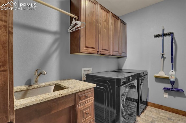 laundry area with cabinets, sink, and independent washer and dryer