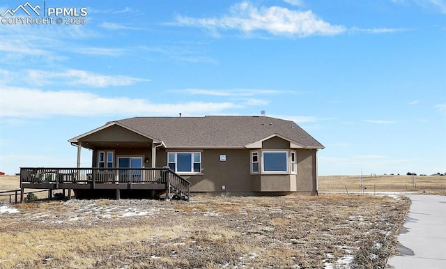 rear view of property with a wooden deck