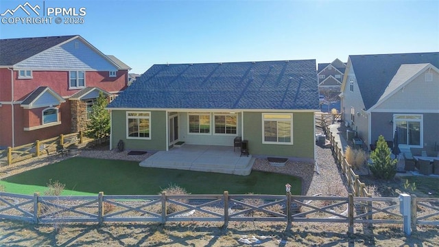 rear view of property featuring a patio area and a lawn