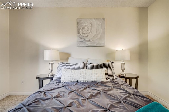 bedroom featuring carpet flooring and a textured ceiling