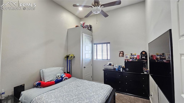 bedroom with a ceiling fan and carpet