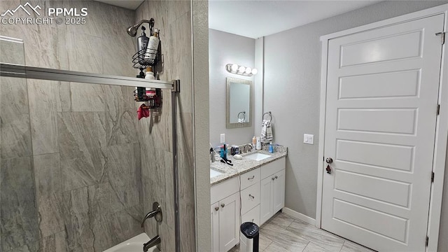 bathroom with double vanity, baseboards, shower / tub combination, marble finish floor, and a sink