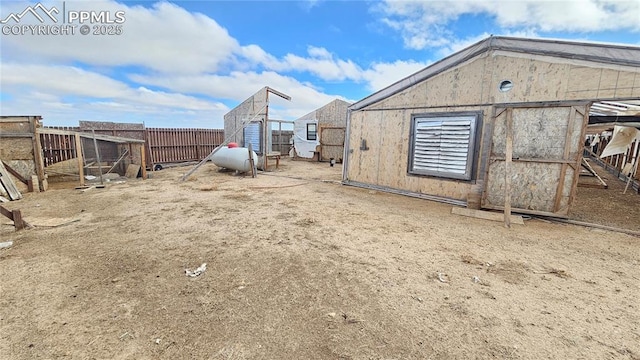 view of yard with an outdoor structure and fence