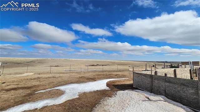 view of yard featuring fence and a rural view