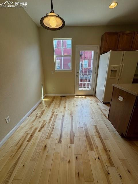 unfurnished dining area with light hardwood / wood-style floors