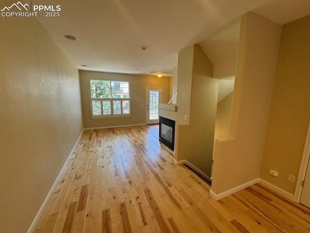 unfurnished living room with light hardwood / wood-style floors