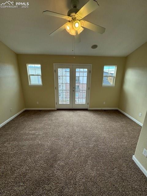 carpeted empty room with french doors and ceiling fan