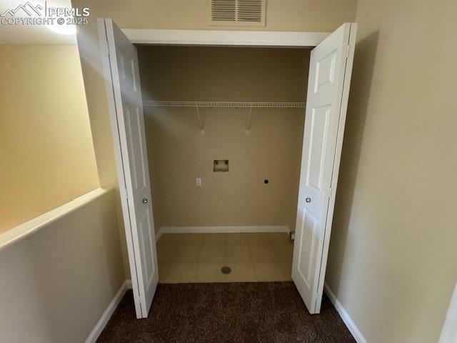 washroom featuring hookup for a washing machine and dark carpet